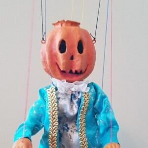 Great pumpkin marionette dressed in bright blue 18th century clothes