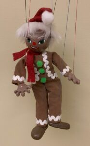 Gingerbread man marionette with Christmas attire